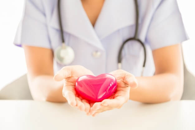 female-nurse-with-stethoscope-holding-heart_1150-15057(1)